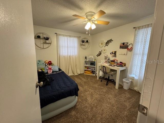 831 Bacon Ave, Sarasota, FL 34232 - bedroom with a ceiling fan, carpet, and a textured ceiling