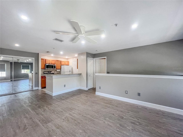 4850 51st St W Unit 4205, Bradenton, FL 34210 - unfurnished living room with baseboards, wood finished floors, visible vents, and ceiling fan