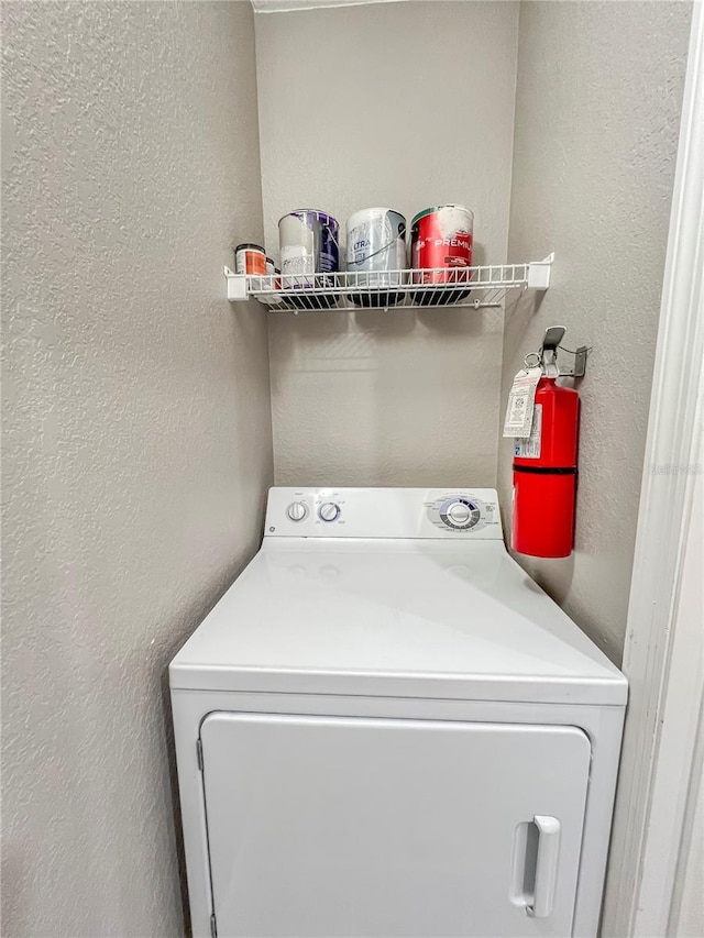 4850 51st St W Unit 4205, Bradenton, FL 34210 - laundry room with a textured wall, laundry area, and washer / dryer
