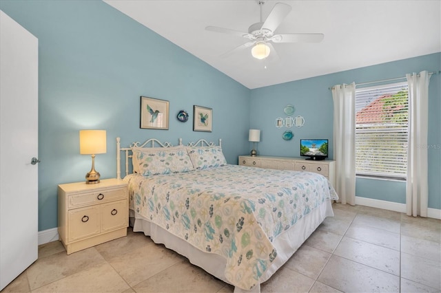 bedroom featuring a ceiling fan, baseboards, vaulted ceiling, and light tile patterned floors