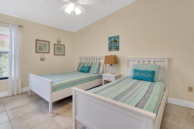 bedroom featuring baseboards, ceiling fan, and lofted ceiling
