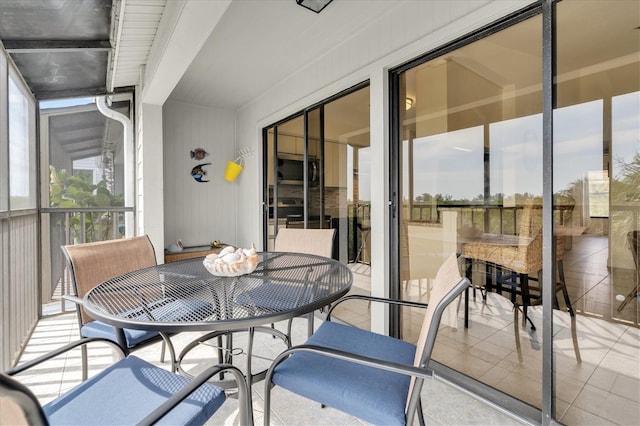 sunroom / solarium featuring outdoor dining area