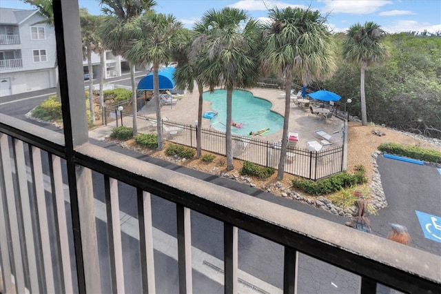 community pool featuring fence and a patio
