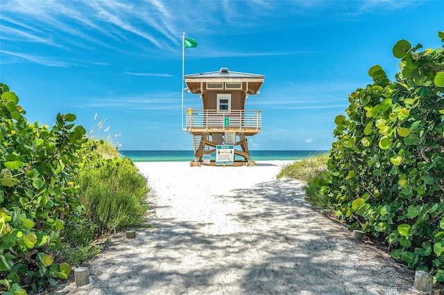 view of community with a beach view and a water view