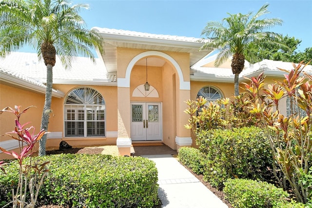 entrance to property featuring stucco siding
