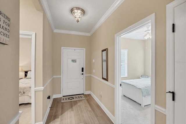 2628 Sapphire Blue Ln, Bradenton, FL 34211 - foyer with light wood-style floors, ornamental molding, ceiling fan, and baseboards