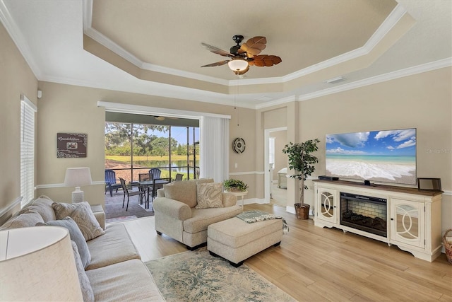 2628 Sapphire Blue Ln, Bradenton, FL 34211 - living area featuring a raised ceiling, ceiling fan, light wood-style flooring, and crown molding