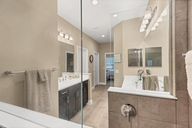 2628 Sapphire Blue Ln, Bradenton, FL 34211 - ensuite bathroom featuring tile patterned floors, two vanities, recessed lighting, and baseboards