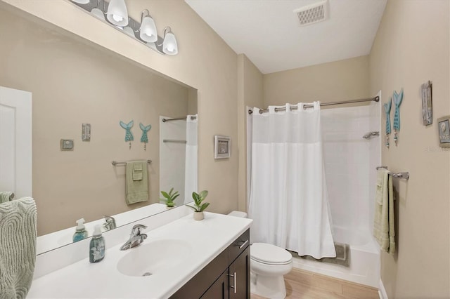 2628 Sapphire Blue Ln, Bradenton, FL 34211 - full bath with vanity, toilet, shower / bathtub combination with curtain, and wood finished floors