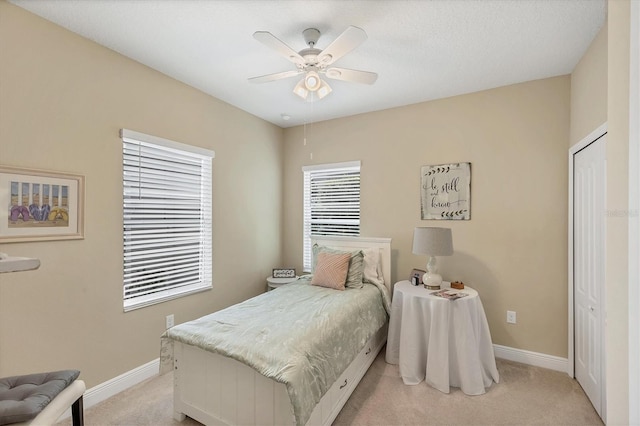 2628 Sapphire Blue Ln, Bradenton, FL 34211 - bedroom featuring light carpet, baseboards, a closet, and a ceiling fan