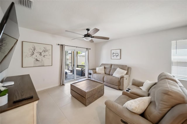 living room with a ceiling fan, light tile patterned flooring, baseboards, and visible vents