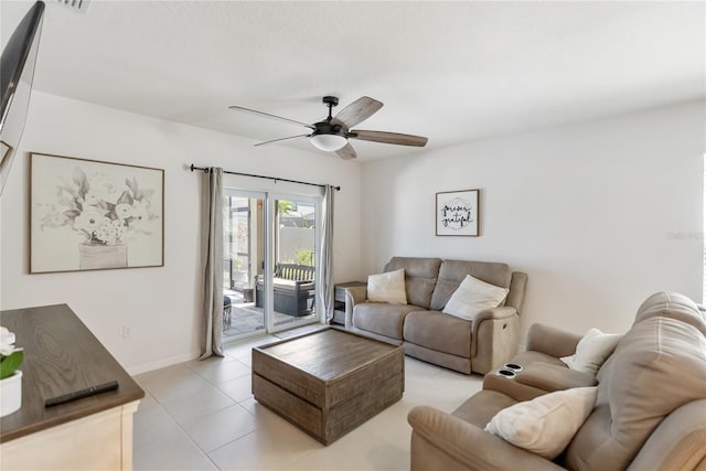 living room featuring baseboards, ceiling fan, and light tile patterned floors