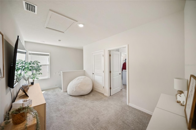 interior space featuring baseboards, attic access, and visible vents