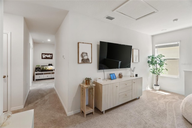 living room featuring baseboards, light colored carpet, and visible vents