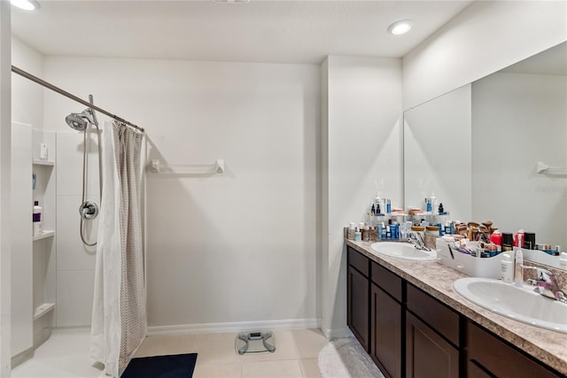 full bathroom with double vanity, a sink, a stall shower, and tile patterned floors