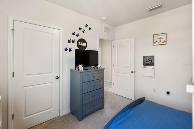 bedroom featuring light carpet and visible vents