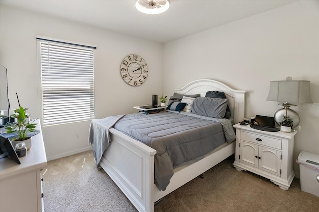 bedroom with baseboards and light colored carpet