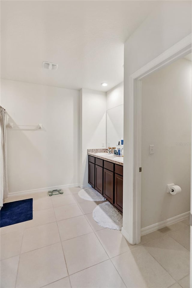 full bath featuring tile patterned flooring, vanity, baseboards, and visible vents