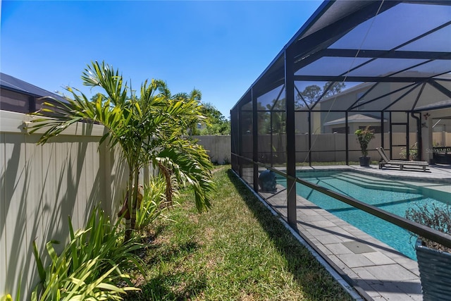 view of pool with a fenced backyard, glass enclosure, and a fenced in pool