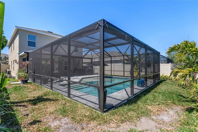 view of swimming pool with a fenced in pool, glass enclosure, fence, and a patio