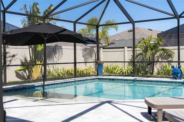 view of swimming pool featuring a fenced in pool, glass enclosure, and fence