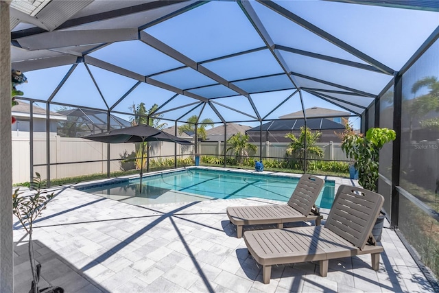 view of swimming pool featuring a fenced in pool, glass enclosure, fence, and a patio
