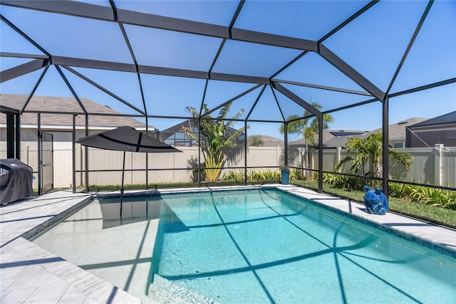 view of swimming pool featuring a fenced backyard, a fenced in pool, area for grilling, and glass enclosure
