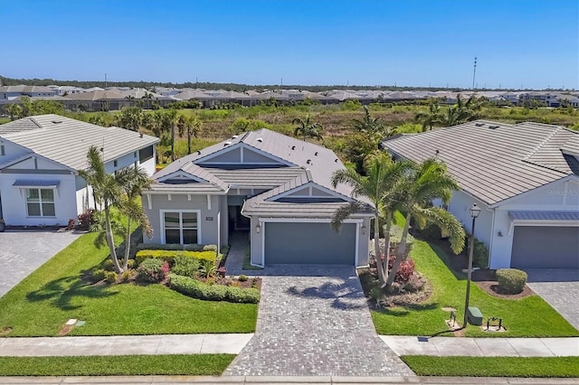 17675 Azul Dr, Lakewood Ranch, FL 34202 - ranch-style home with a front yard, a residential view, a garage, and decorative driveway