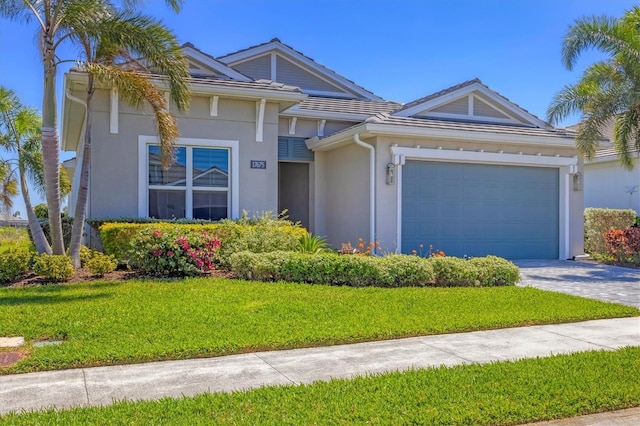 17675 Azul Dr, Lakewood Ranch, FL 34202 - view of front of property featuring driveway, stucco siding, an attached garage, and a front lawn