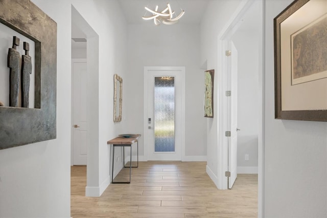 17675 Azul Dr, Lakewood Ranch, FL 34202 - entryway with wood finished floors, an inviting chandelier, and baseboards