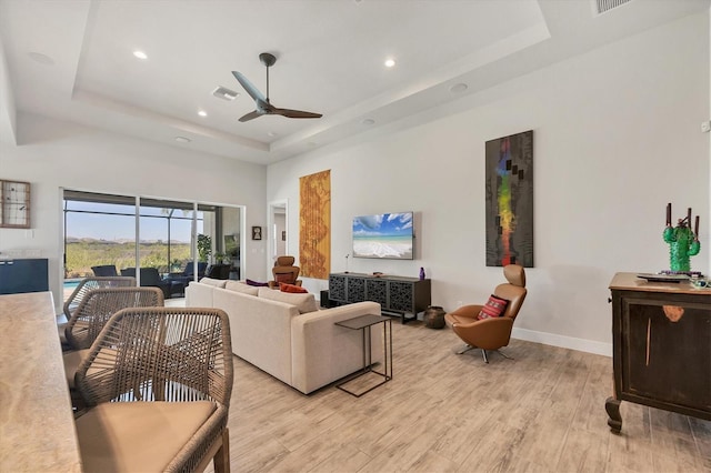 17675 Azul Dr, Lakewood Ranch, FL 34202 - living room featuring baseboards, light wood-type flooring, recessed lighting, a ceiling fan, and a tray ceiling