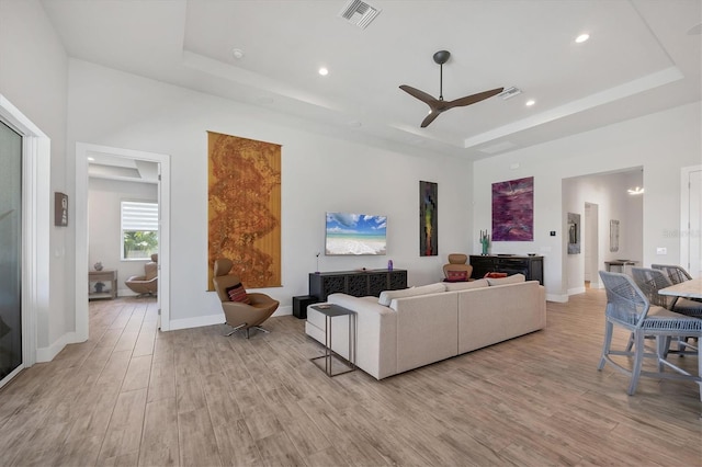 17675 Azul Dr, Lakewood Ranch, FL 34202 - living area with a tray ceiling, light wood-type flooring, and visible vents