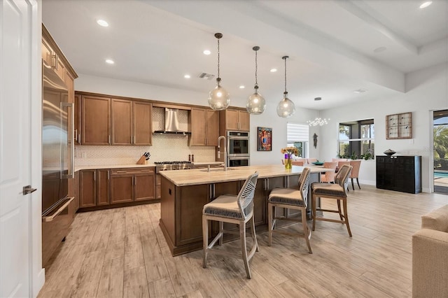 17675 Azul Dr, Lakewood Ranch, FL 34202 - kitchen with visible vents, wall chimney exhaust hood, light countertops, a breakfast bar, and recessed lighting