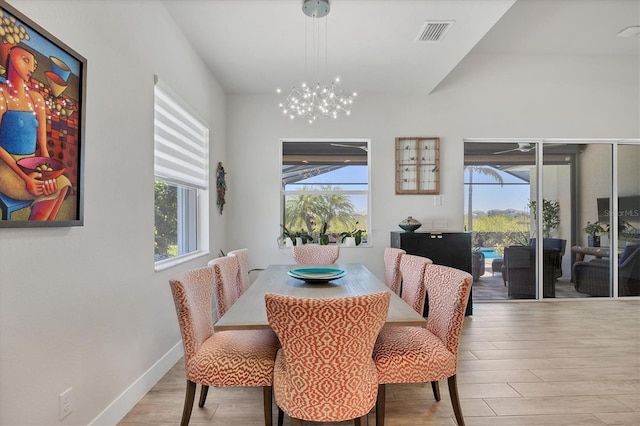 17675 Azul Dr, Lakewood Ranch, FL 34202 - dining room featuring visible vents, baseboards, an inviting chandelier, and wood finished floors