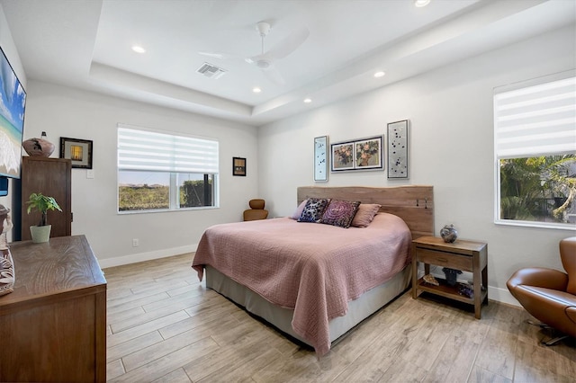 17675 Azul Dr, Lakewood Ranch, FL 34202 - bedroom with a raised ceiling, recessed lighting, baseboards, and light wood-style flooring
