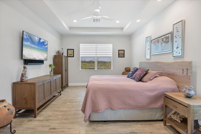 17675 Azul Dr, Lakewood Ranch, FL 34202 - bedroom featuring visible vents, recessed lighting, a raised ceiling, and light wood-style floors