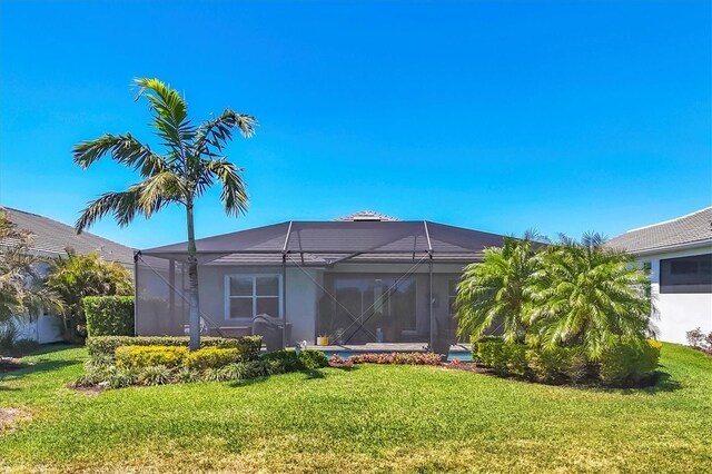 17675 Azul Dr, Lakewood Ranch, FL 34202 - back of house with a lanai and a lawn