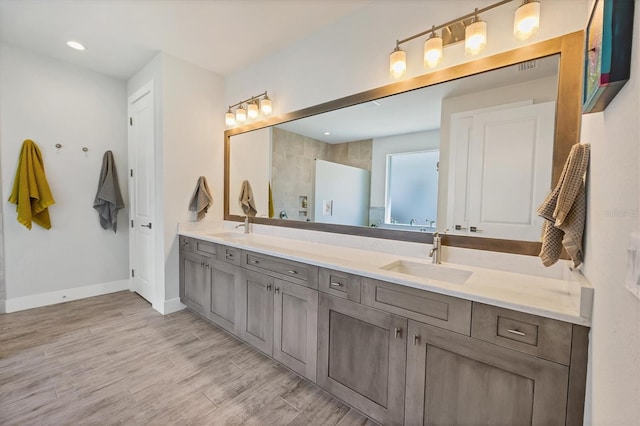 17675 Azul Dr, Lakewood Ranch, FL 34202 - full bath featuring double vanity, baseboards, a sink, and wood finished floors