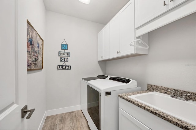 17675 Azul Dr, Lakewood Ranch, FL 34202 - washroom with baseboards, a sink, light wood finished floors, cabinet space, and washing machine and dryer