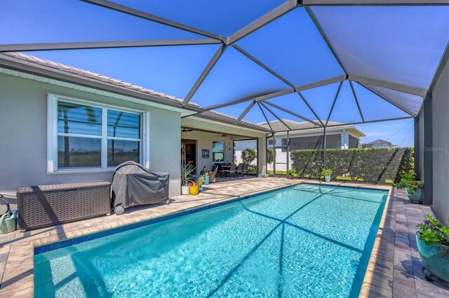 17675 Azul Dr, Lakewood Ranch, FL 34202 - view of pool featuring area for grilling, ceiling fan, glass enclosure, a patio, and a fenced in pool
