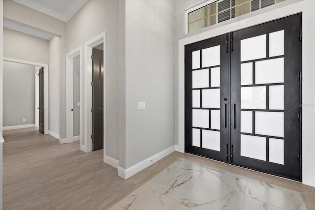 9241 Starry Night Ave, Sarasota, FL 34241 - foyer entrance featuring marble finish floor, baseboards, french doors, and a healthy amount of sunlight