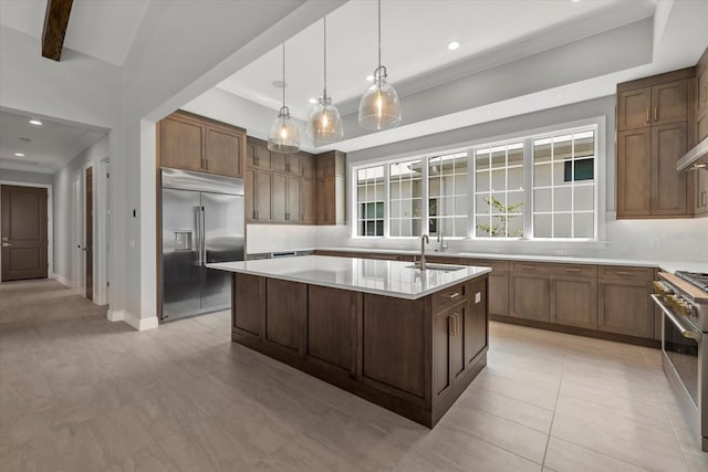 9241 Starry Night Ave, Sarasota, FL 34241 - kitchen featuring light countertops, crown molding, a kitchen island with sink, high end appliances, and a sink