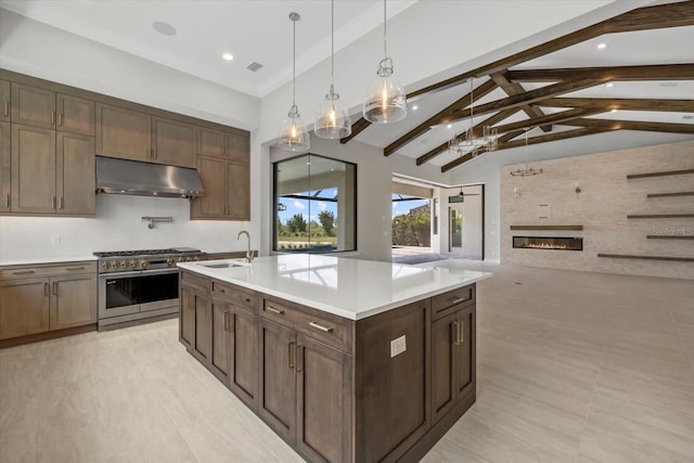9241 Starry Night Ave, Sarasota, FL 34241 - kitchen with light countertops, beamed ceiling, high end stainless steel range oven, under cabinet range hood, and a sink