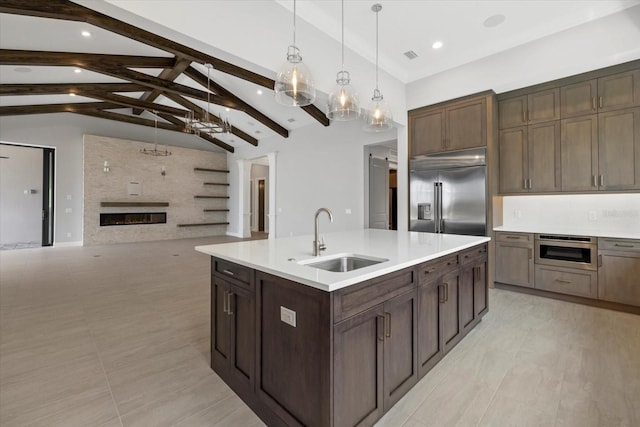 9241 Starry Night Ave, Sarasota, FL 34241 - kitchen with built in fridge, light countertops, a sink, and a chandelier
