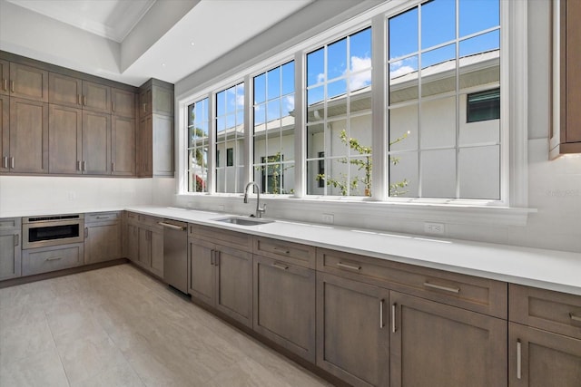 9241 Starry Night Ave, Sarasota, FL 34241 - kitchen featuring stainless steel dishwasher, light countertops, and a sink