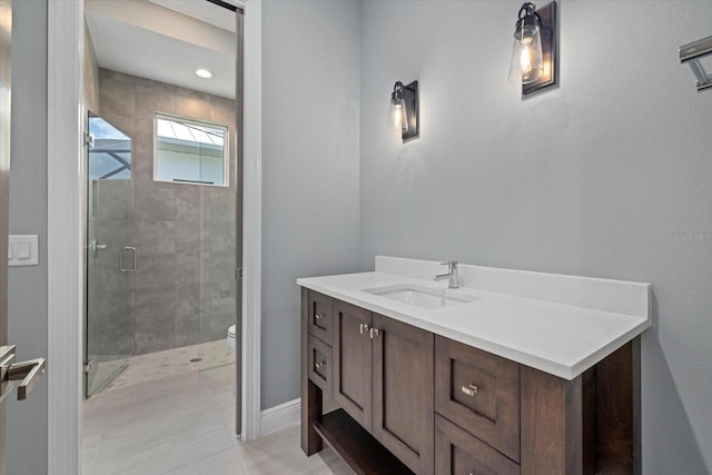 9241 Starry Night Ave, Sarasota, FL 34241 - bathroom featuring vanity, toilet, baseboards, tile patterned floors, and a stall shower