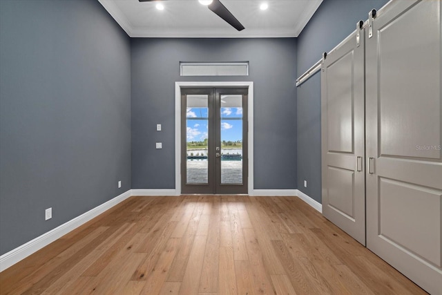 9241 Starry Night Ave, Sarasota, FL 34241 - doorway to outside with baseboards, ornamental molding, a ceiling fan, a barn door, and light wood-type flooring