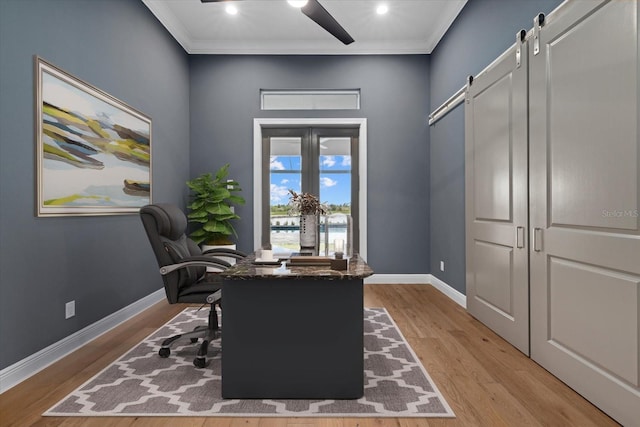 9241 Starry Night Ave, Sarasota, FL 34241 - office with crown molding, baseboards, a barn door, and light wood-style floors