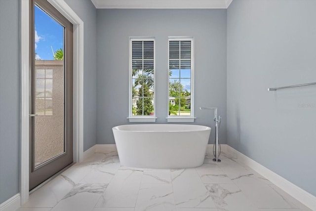 9241 Starry Night Ave, Sarasota, FL 34241 - full bathroom with baseboards, marble finish floor, ornamental molding, and a freestanding bath