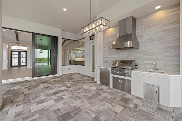 9241 Starry Night Ave, Sarasota, FL 34241 - kitchen featuring light countertops, a sink, wall chimney exhaust hood, and a chandelier